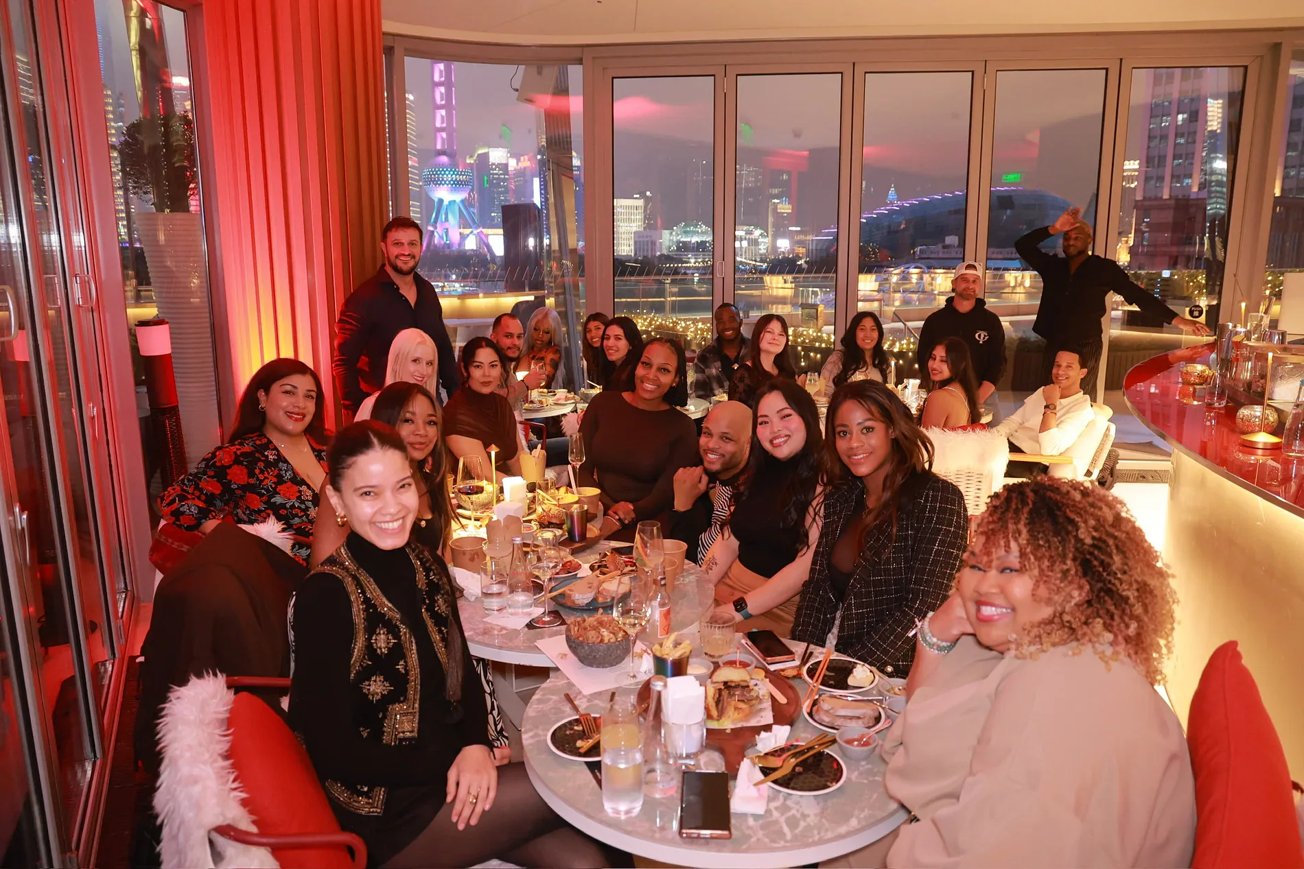 The collective sharing dinner around a long table