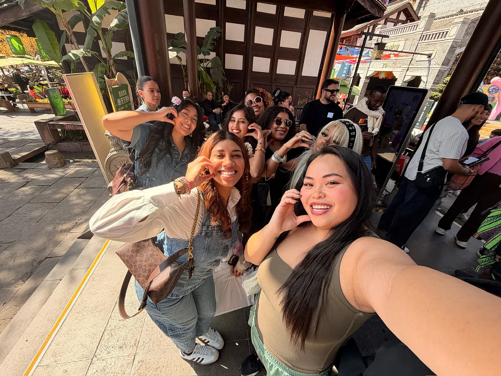 Olivia and the group sharing a smiling selfie during a day out